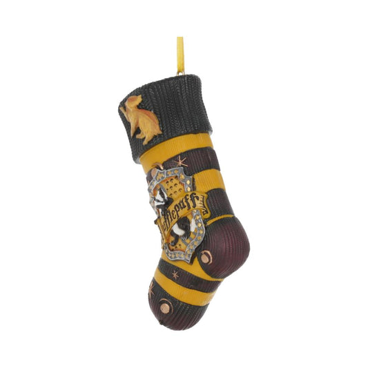 A Christmas stocking ornament features yellow and black stripes with a "Hufflepuff" crest, hanging against a white background. A yellow animal figure is attached near the top.