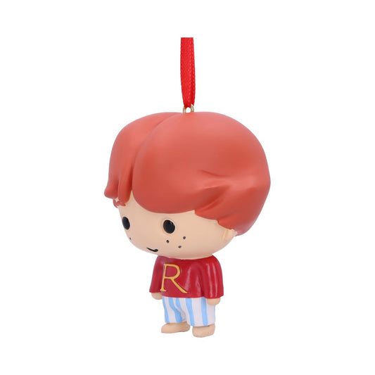 A small, cartoonish figurine with red hair hangs from a red string. It wears a red shirt with a yellow "R" and striped pants. The background is plain white.