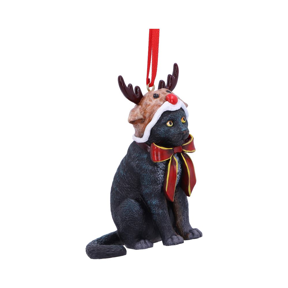 Black cat ornament sits wearing a brown reindeer hat with red nose and antlers and a red-and-gold bow, suspended by a red ribbon against a white background.