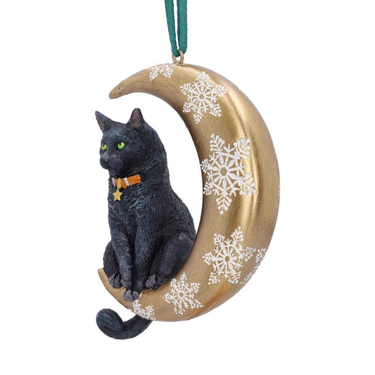 Black cat figurine sits on a gold crescent moon decorated with white snowflakes, wearing an orange collar with a star, hanging by a green ribbon against a white background.