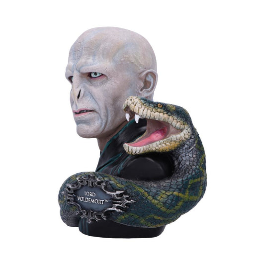 A detailed bust depicts a pale, bald figure with snake-like eyes and a sneering expression, accompanied by a coiled, open-mouthed snake. Text reads “Lord Voldemort™”. The background is white.