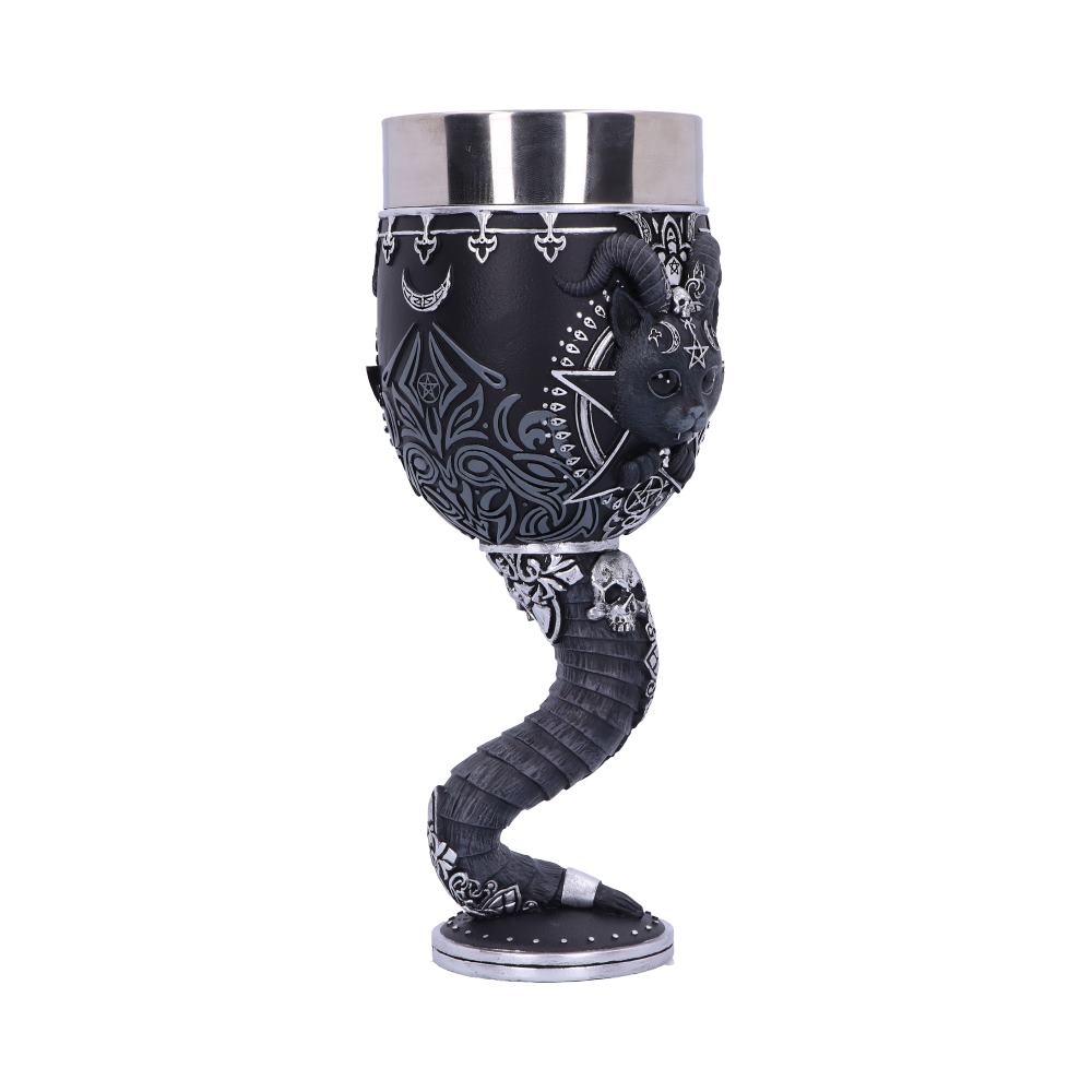 A metal goblet stands on a white background; the base is a dragon tail with small skulls, the cup shows a cat with horns surrounded by stars, pentagrams, and filigree.