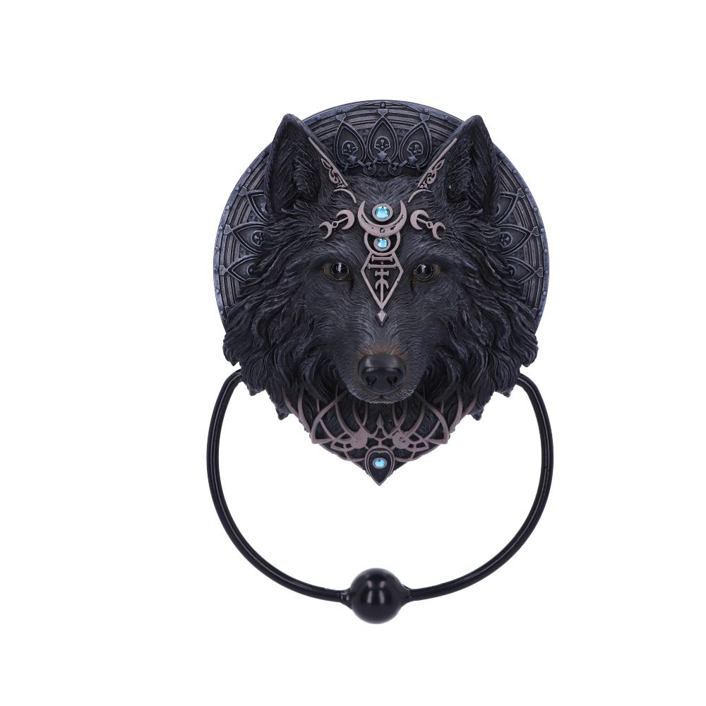 A decorative wolf head door knocker featuring intricate designs, including blue gemstones and tribal patterns, is mounted against an ornate circular background with gothic motifs.
