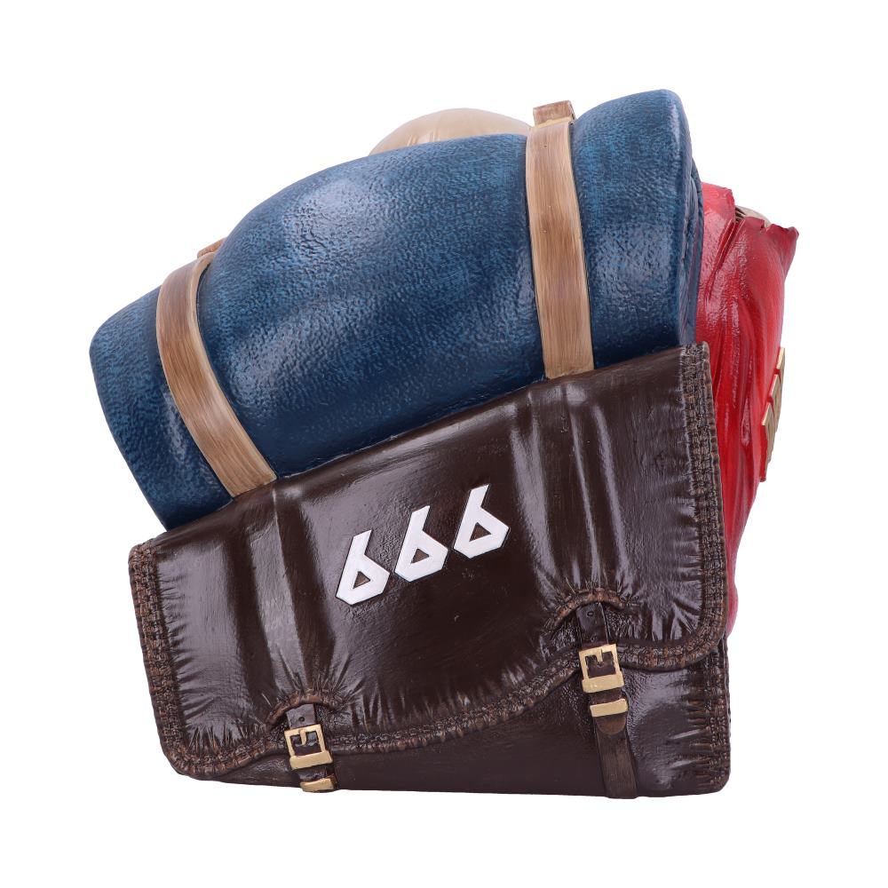A sculpted backpack with a blue sleeping bag and red object attached. The brown bag displays white numbers "666" on the flap, with straps and buckles securing it.