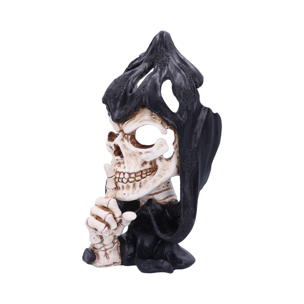 A skeleton with a black cowl over its head is bringing its finger to its teeth, gesturing to be quiet. It's posed in front of a white background.