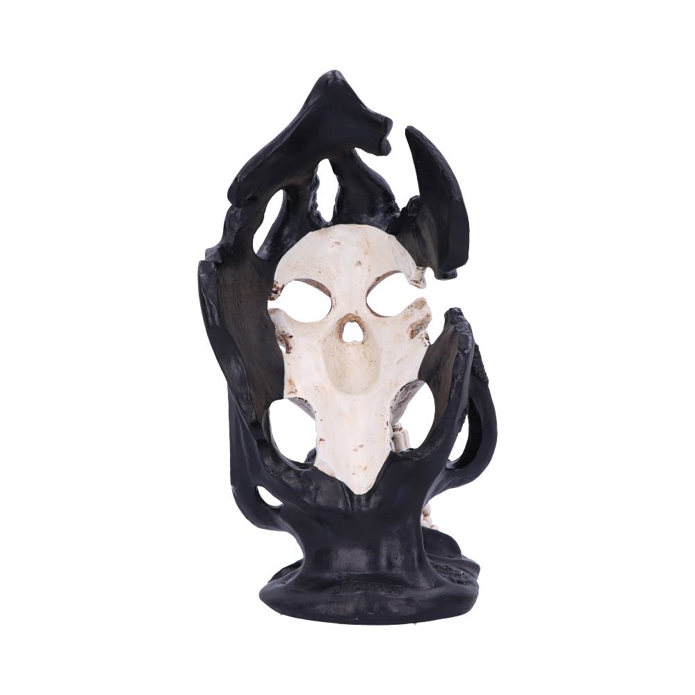 A white skull statue is framed by black tendrils, mounted on a black base, all against a stark white background.