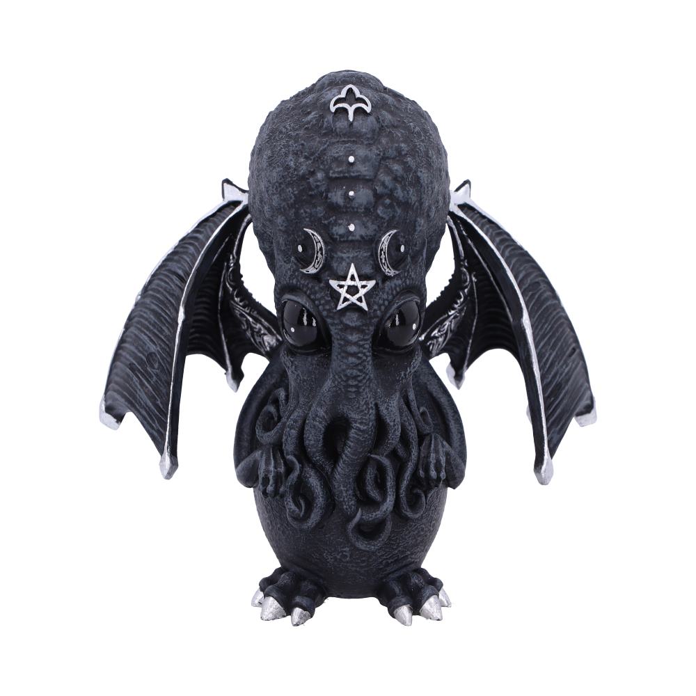 A dark-gray Cthulhu figurine stands on a white surface. It has small black eyes, a starfish, crescent moons, and other symbols on its head. It has wings and tentacles.