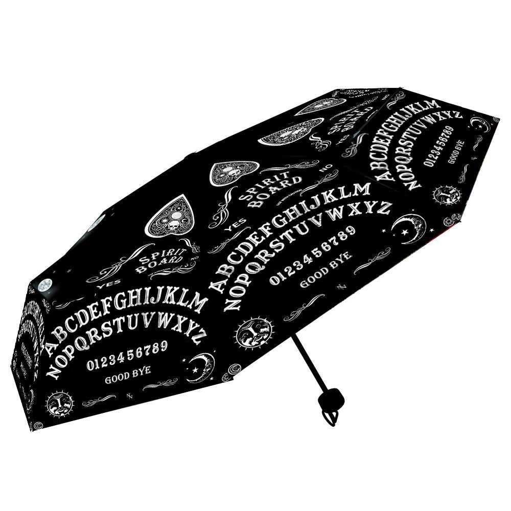A black umbrella, featuring a Ouija board design, is shown slightly opened against a white background.