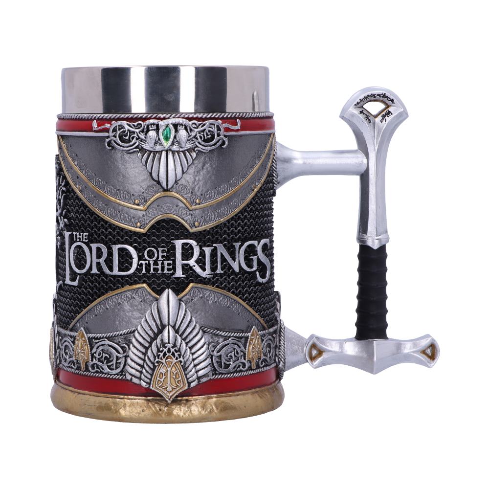 A decorative mug with ornate silver detailing resembling armor, featuring "THE LORD OF THE RINGS" text. The handle resembles a sword hilt; the base is gold, against a plain white background.