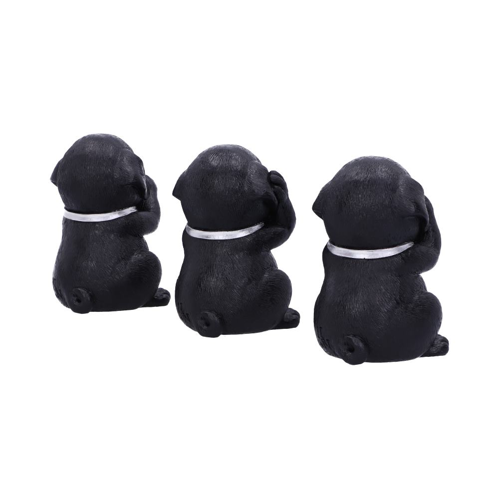 Three black pug figurines sit in a row on a white surface. Each covers its eyes with its paws, wearing a white collar.