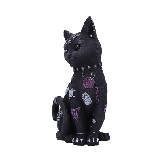 A black cat figurine adorned with decorative patterns and symbols like yarn, skulls, and flowers sits upright. The text "CAT NIP" is on its base.