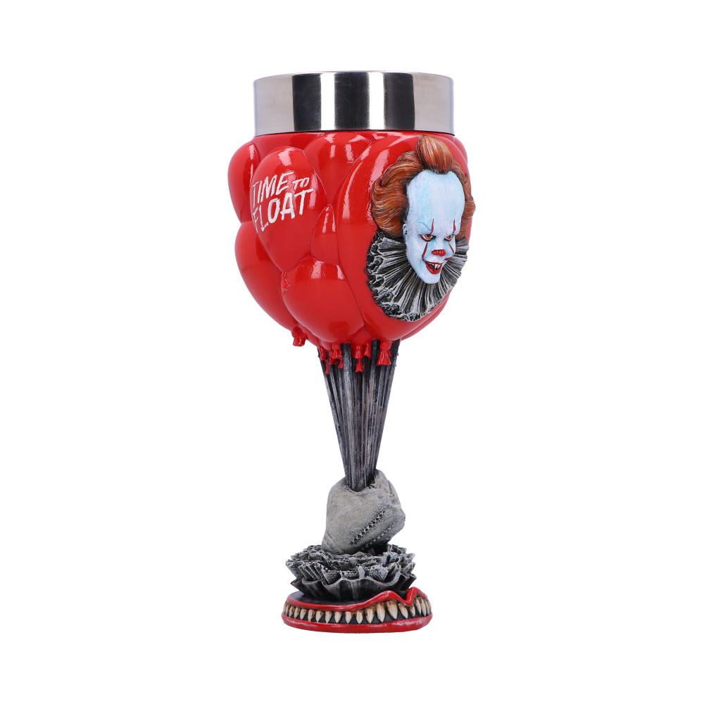 A decorative goblet featuring Pennywise, the clown from "It," stands on a white background. The goblet has a metal top and features red balloons with the phrase, "TIME TO FLOAT!" It is held by a sinister hand atop a base with sharp teeth.