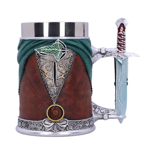 A medieval-themed mug depicts a dagger embedded in a brown and turquoise textured design, resembling clothing. Silver ornamental details enhance its appearance, with the handle shaped like a sword hilt.