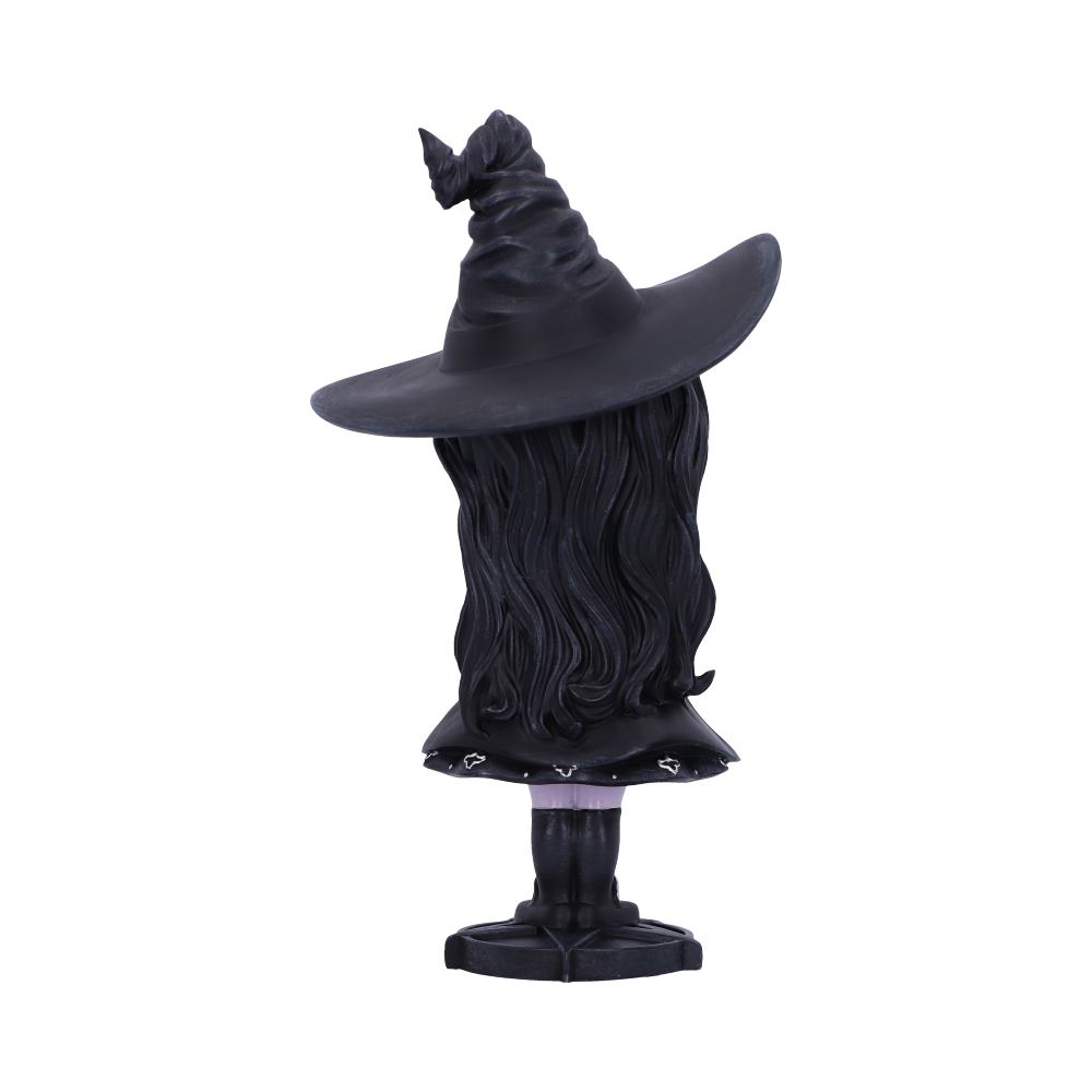 A black witch hat with long, flowing hair rests on a stand, facing away. The environment is a plain, white background.