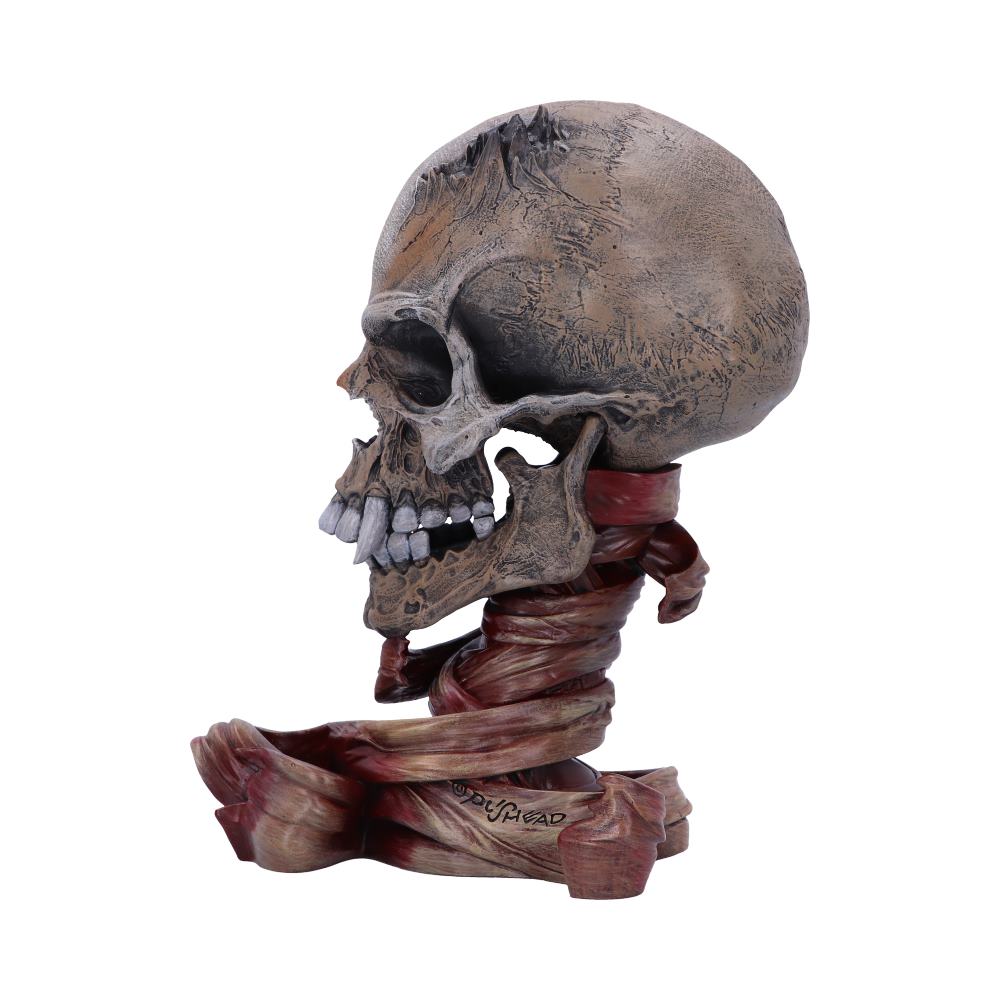 A realistic skull sculpture with prominent teeth rests atop twisted, ribbon-like structures. The base features dark red hues, and "DUSHIHEAD" is inscribed. The backdrop is plain white.
