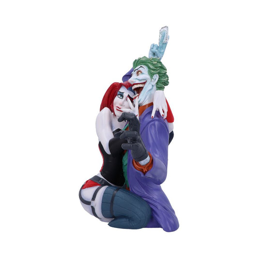 Two stylized figures embrace closely; one with green hair smiles widely, holding a card, while a red-haired figure wraps arms around him in a playful, intimate gesture. Plain white background.