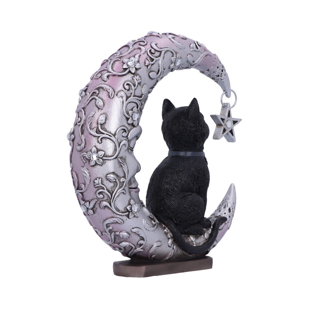 A black cat figurine sits on a detailed, ornate crescent moon adorned with floral designs, with a star-shaped ornament hanging nearby, set on a small brown base.