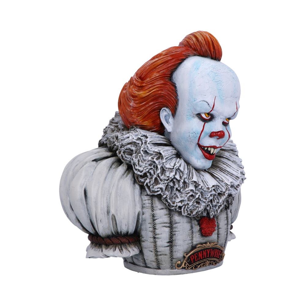 Pennywise bust statue is on display. The painted clown figure has orange hair, a white ruff collar, and a plaque that reads "PENNYWISE," and is in a plain, white space.