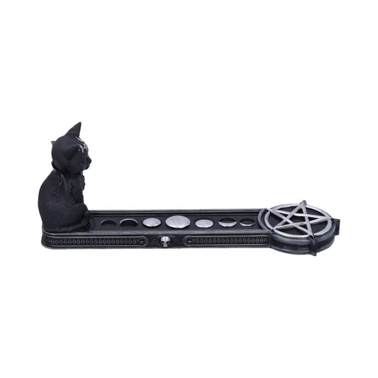 A black, seated cat statue sits at the end of a long tray that has depictions of the phases of the moon and ends with a pentagram symbol.