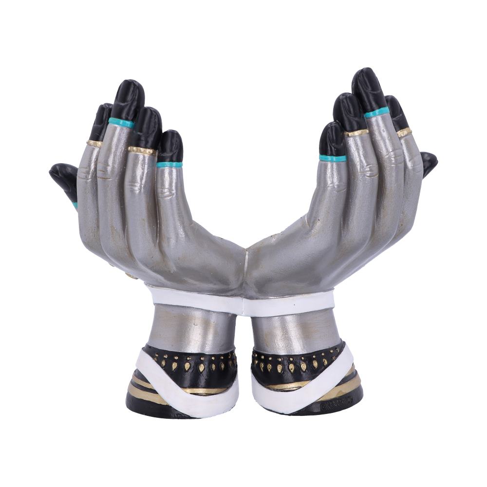 Two stylized, silver hands are held upwards, palms facing, against a white backdrop. The hands have black nails with a thin turquoise stripe and are adorned with gold rings. The wrists are joined with a white band and have decorative black cuffs.