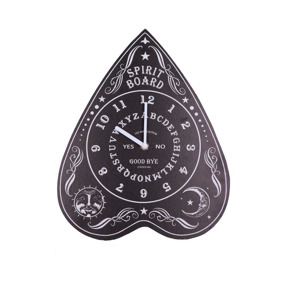 A clock designed like a spirit board with white numbers and letters on a black background. It includes the text: "SPIRIT BOARD," "YES," "NO," "GOOD BYE," and "USE WITH CAUTION." Ornate designs with moon and sun motifs feature in corners.