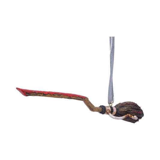 A decorative broomstick is suspended from a silver ribbon, featuring a red and brown handle with intricate details, set against a plain white background.