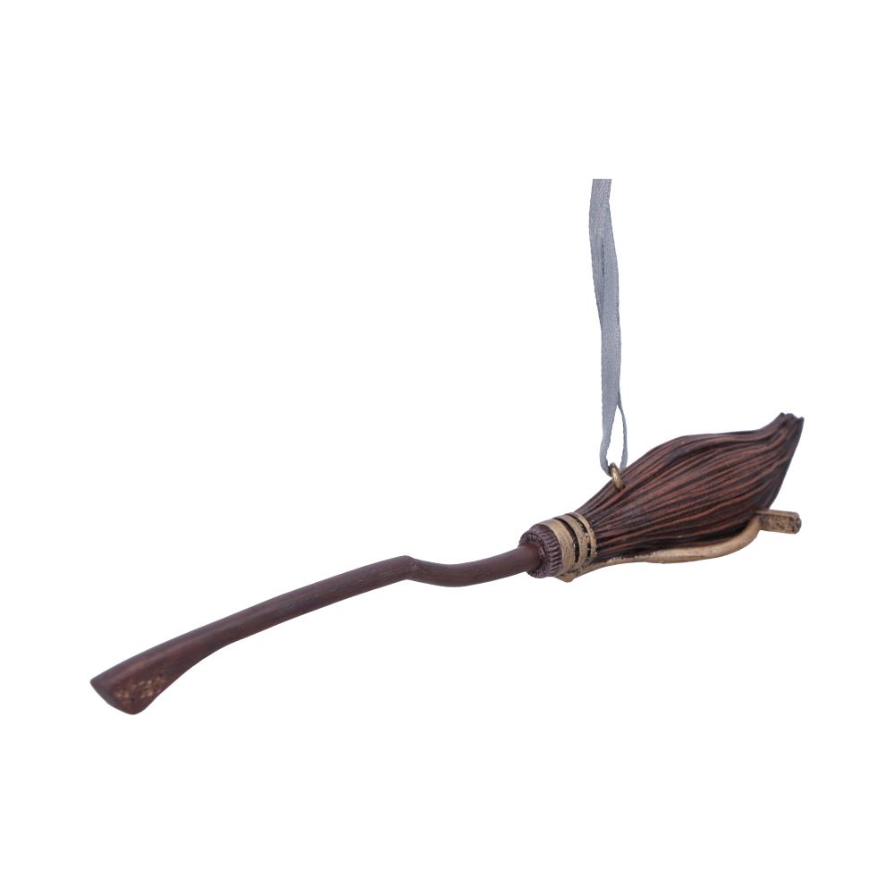 Wooden broomstick ornament hangs by a gray ribbon, featuring a curved handle and detailed bristles, against a plain white background.