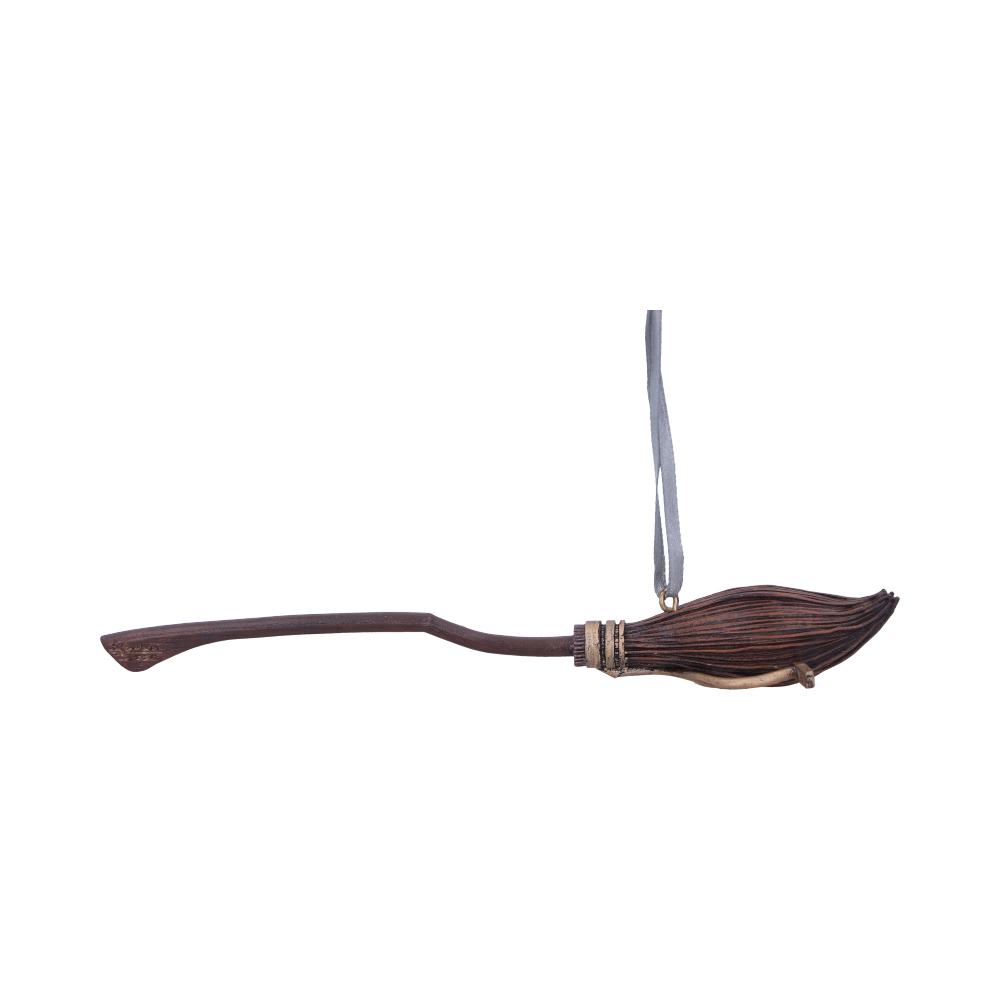 A small decorative broomstick hangs in the air, featuring a wooden handle and bound twig bristles, suspended by a thin gray ribbon against a white background.