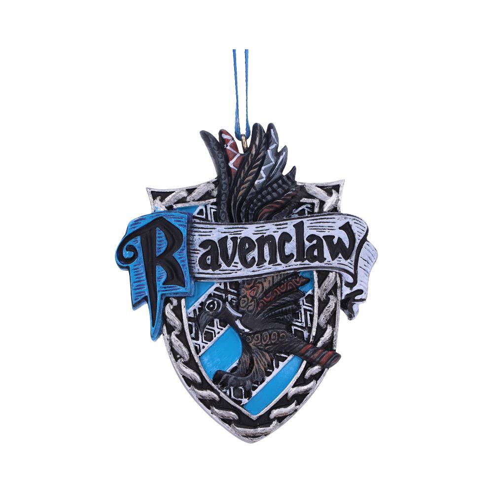 A shield-shaped ornament features the word "Ravenclaw" with a stylized eagle and blue ribbon. It hangs from a blue string against a white background.