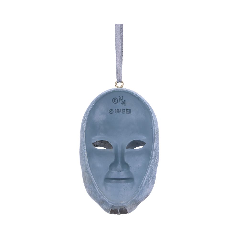 A blue-grey mask hanging from a ribbon. The mask features eye and mouth cutouts with text that reads "© N" and "© WBEI." It floats against a white background.