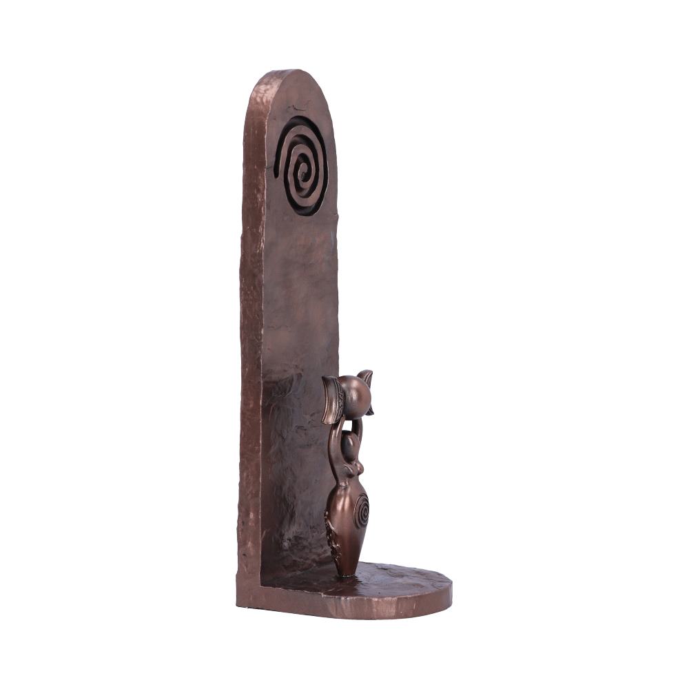 Bronze bookend features a cat figure with spiral designs, standing against a tall vertical slab with a spiral motif, creating an artistic and functional piece for book support.