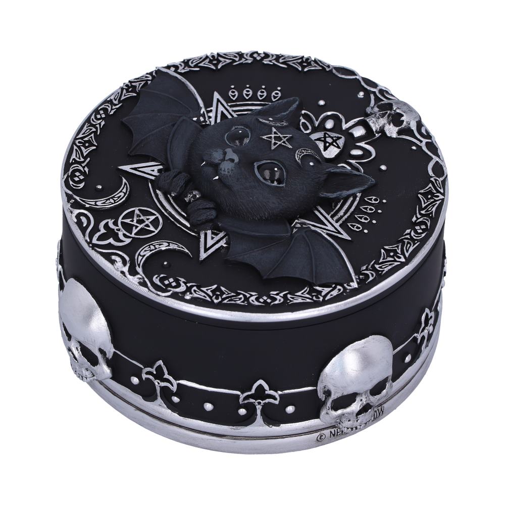 A round, black decorative box features a central bat with intricate details and surrounding celestial and pentagram patterns. Silver skull motifs encircle the sides, enhancing its gothic style.