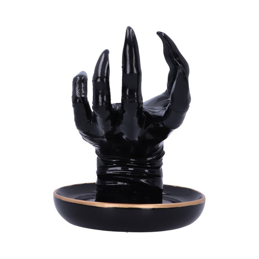 A black, glossy hand sculpture with extended fingers emerges from a circular black base with a thin, gold rim, suggesting a decorative or artistic context.