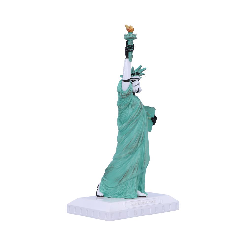 A greenish statue features a Stormtrooper wearing a robe like the Statue of Liberty, holding a torch and tablet, standing on a white base. The background is plain white.