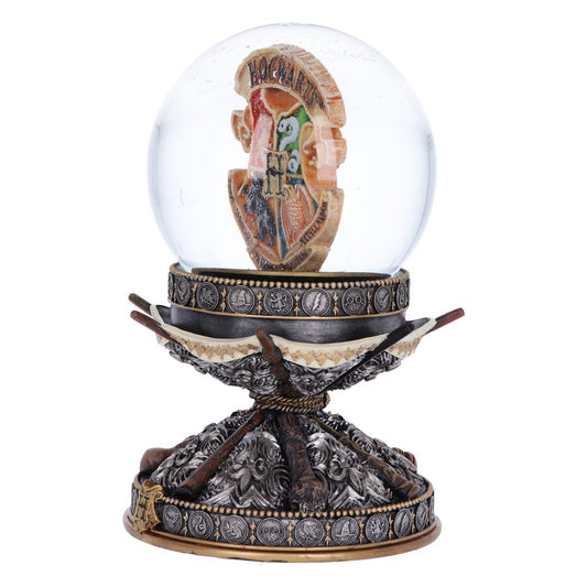 A glass sphere encases a colorful emblem with the text "HOGWARTS," resting on an ornate, metallic base adorned with symbols, supported by branching elements and a decorative stand.
