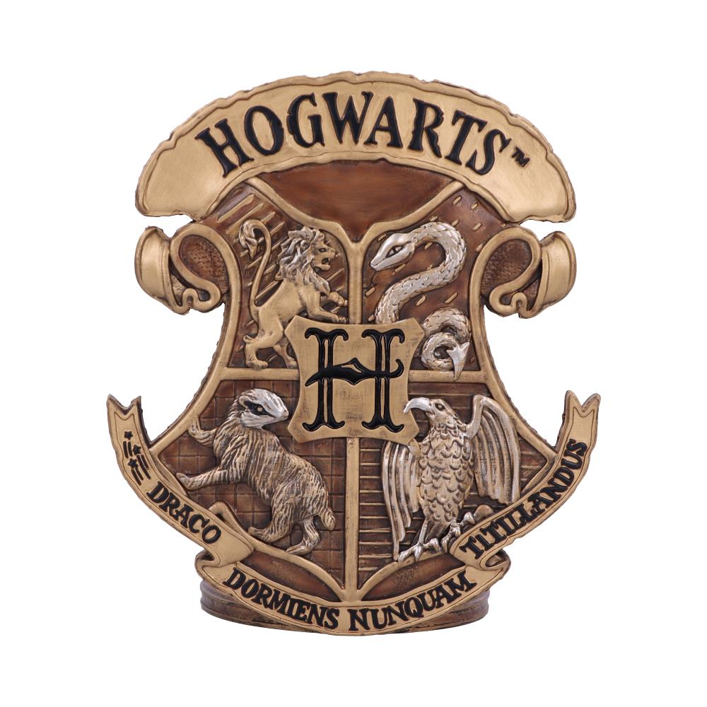 An ornate, golden crest features a lion, snake, badger, and eagle surrounding a central "H." Text reads "HOGWARTS," and a banner below states "DRACO DORMIENS NUNQUAM TITILLANDUS."