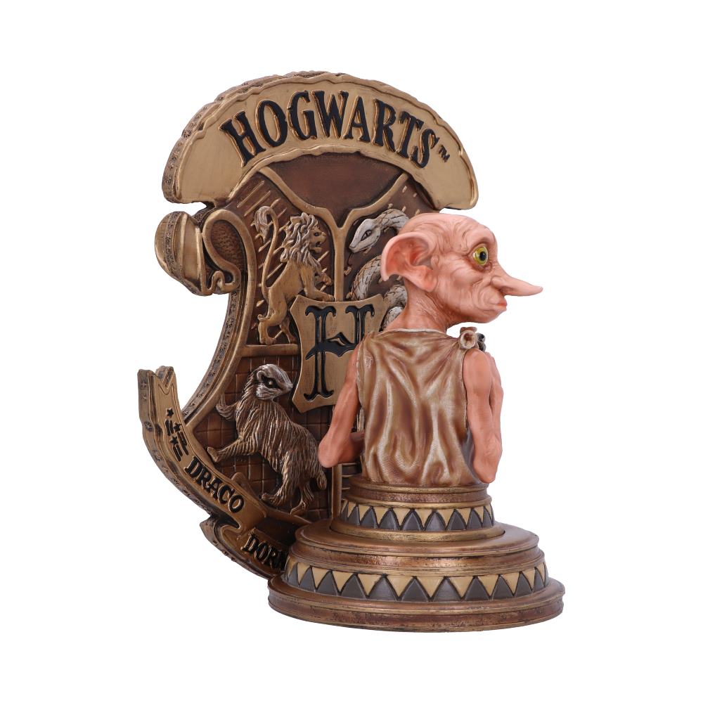 A detailed figurine of a character stands beside a large, ornate Hogwarts crest with animal symbols and the letters "H" and "Draco Dormiens" etched.