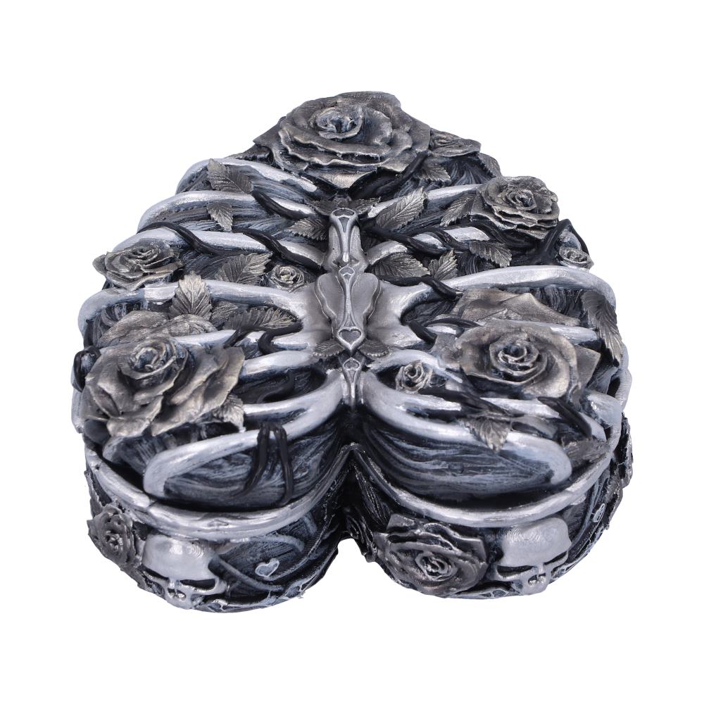 Heart-shaped decorative box adorned with intricate metallic roses and entwined ribcage motifs, set against a plain white background.