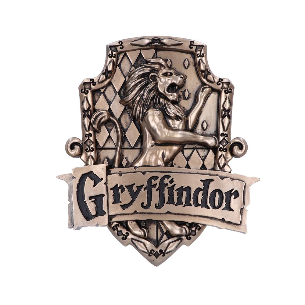 A bronze crest features a lion standing on hind legs, roaring. Below, a banner reads "Gryffindor." The background displays a diamond pattern, framed by ornate border details.