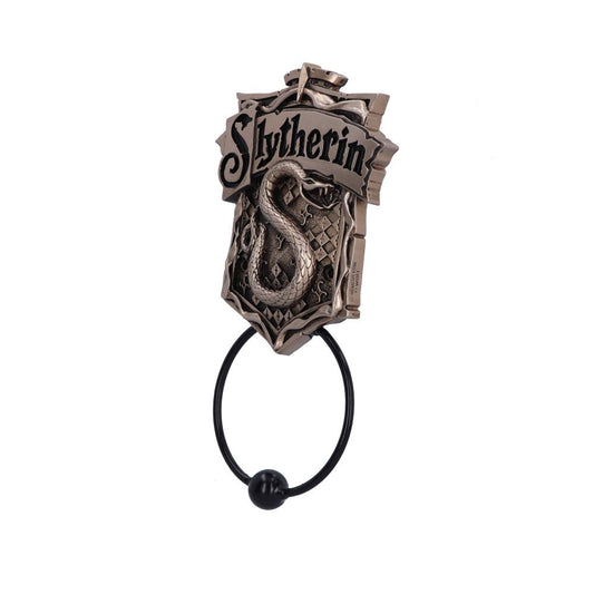 A metal door knocker features a coiled snake and the text "Slytherin" above it, set on a shield with diamond patterns, against a plain background.