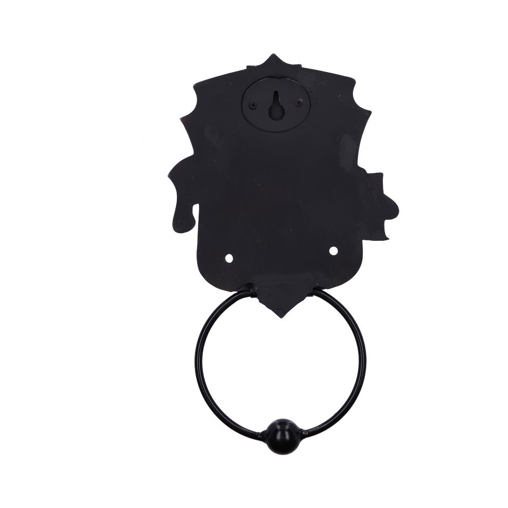 A black, ornate door knocker with a circular ring hangs against a white background. It features a decorative backplate with a keyhole shape near the top.