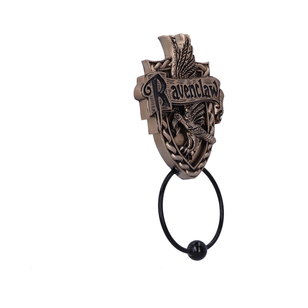 A bronze-colored door knocker featuring the word "Ravenclaw" above an intricately designed raven. A round handle hangs below, set against a plain white background.