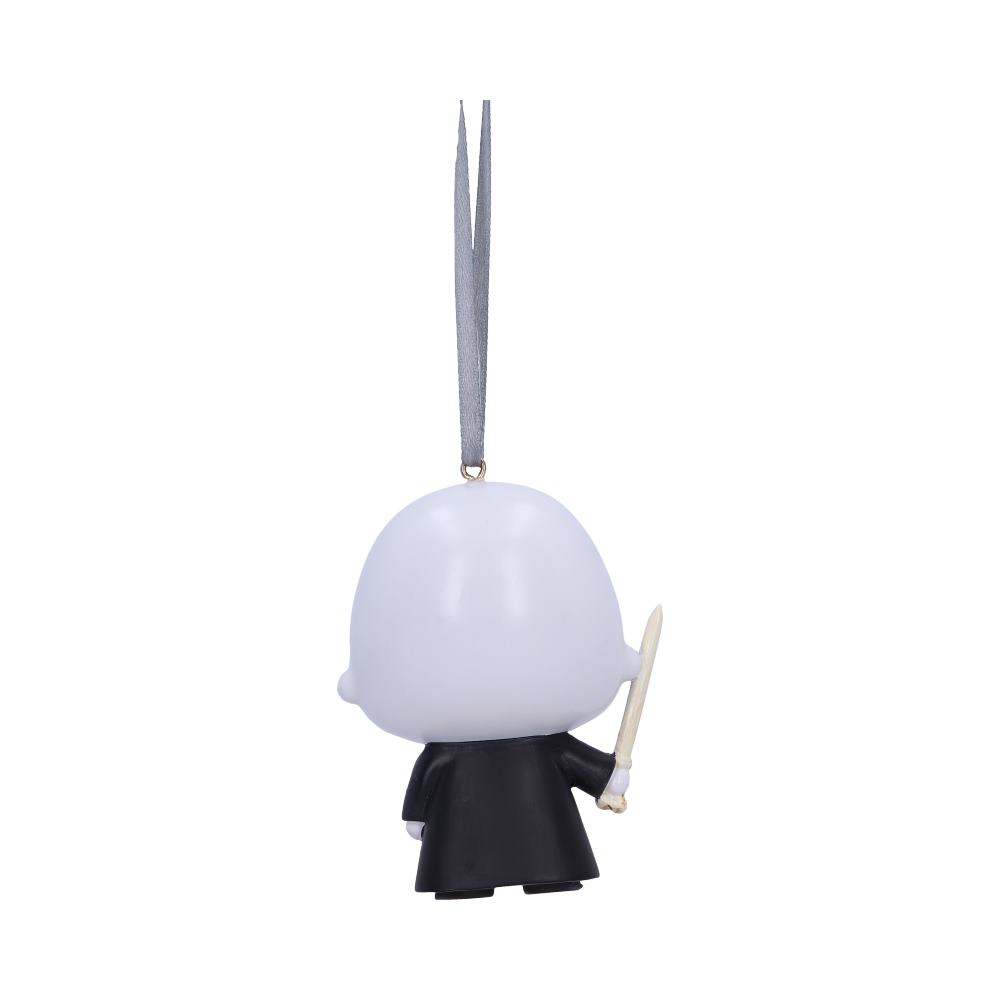 A small, bald-headed figurine holding a wand is hanging by a looped ribbon, facing away. It wears a black robe and is set against a plain white background.