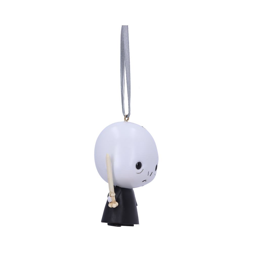 A small, stylized figure with a round head and black eyes, holding a wand and wearing a black cloak, hangs by a looped ribbon against a white background.