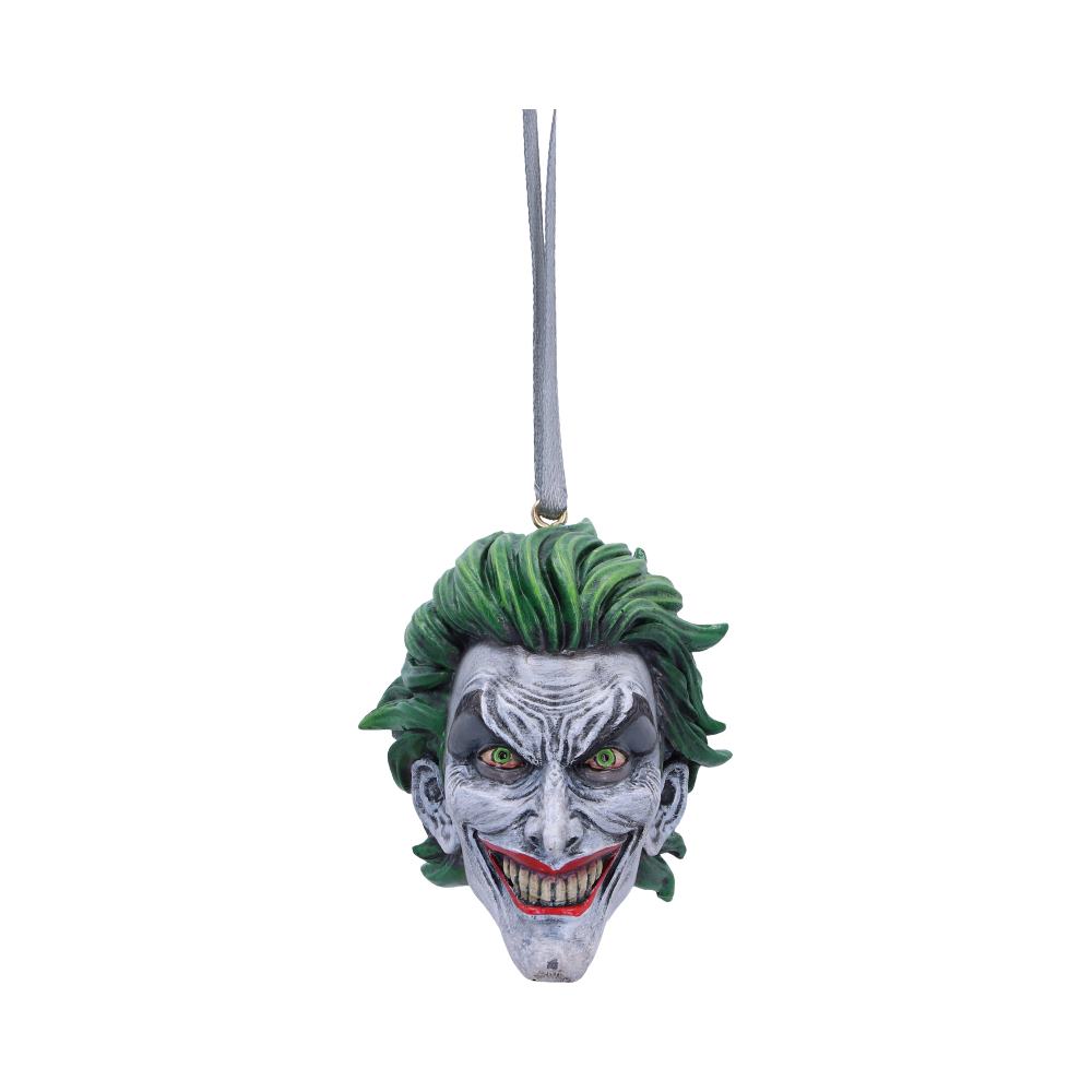 A Joker-themed ornament features a grinning face with green hair, suspended by a silver string. The white backdrop highlights the mischievous expression and vivid colors.