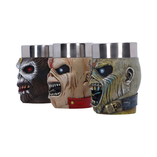 Three metal can holders feature grotesque, monster-like faces with open mouths and vivid colors. They are side by side, displaying detailed textures. The background is plain white.