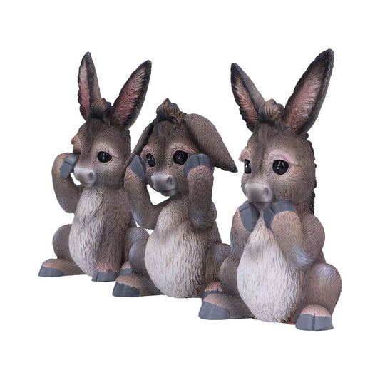 Three donkey figurines sit side-by-side. They are posed: "see no evil," "hear no evil," and "speak no evil" respectively, against a white background.