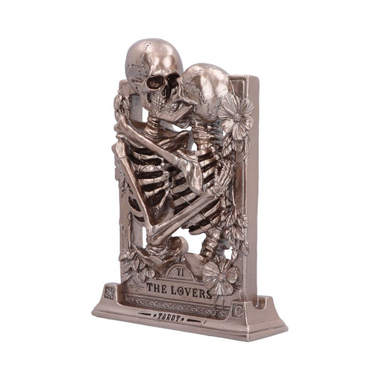 Two metallic skeletons hug on a stand reading "VI THE LOVERS TAROT" against a white background.