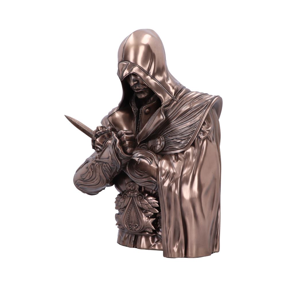 A metallic statue depicts a hooded figure inspecting a small knife, adorned in intricate armor. The setting is isolated with no additional context. No text is present.
