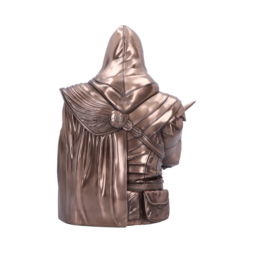 A bronze-colored statue of a hooded figure with a detailed cloak, carrying a satchel, stands isolated against a white background.